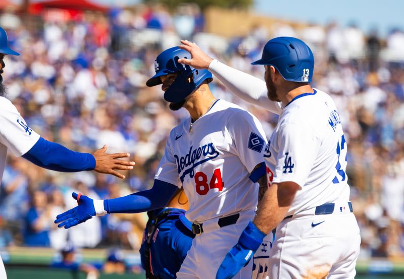 Mar 2, 2024; Phoenix, Arizona, USA; Los Angeles Dodgers outfielder Andy Pages celebrates with teammates after hitting a three run home run against the Chicago Cubs during a spring training game at Camelback Ranch-Glendale. Mandatory Credit: Mark J. Rebilas-USA TODAY Sports