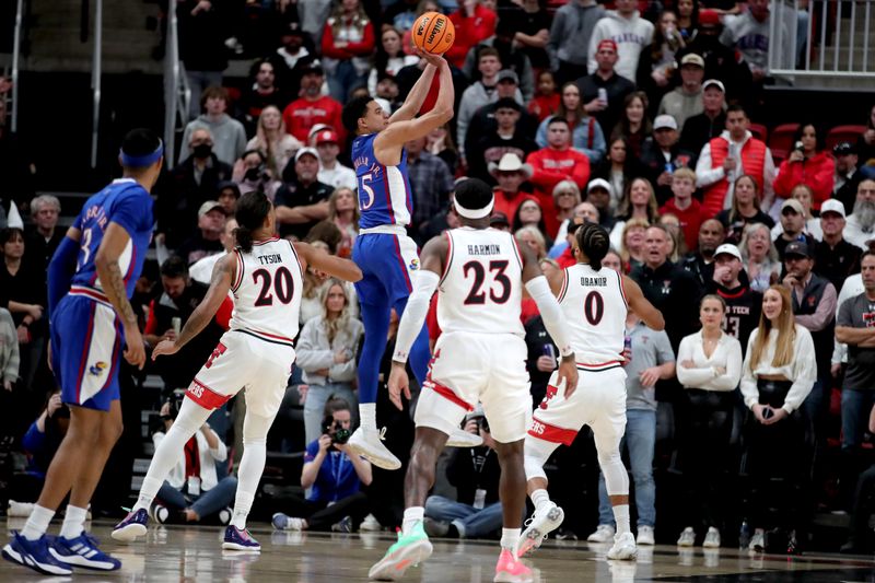 Jan 3, 2023; Lubbock, Texas, USA;  Kansas Jayhawks guard Kevin McCullar Jr (15) shoots over Texas Tech Red Raiders forward Kevin Obanor (0) in the first half at United Supermarkets Arena. Mandatory Credit: Michael C. Johnson-USA TODAY Sports