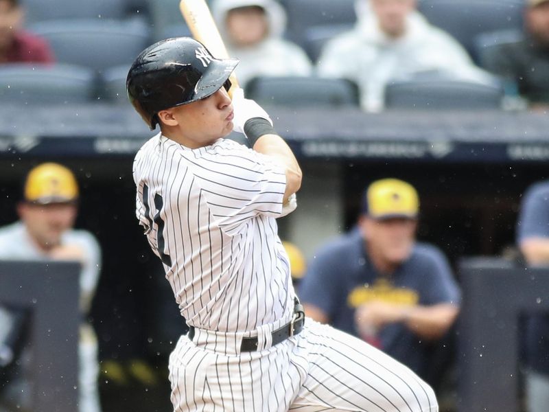 Sep 9, 2023; Bronx, New York, USA;  New York Yankees shortstop Anthony Volpe (11) hits an RBI single in the fourth inning against the Milwaukee Brewers at Yankee Stadium. Mandatory Credit: Wendell Cruz-USA TODAY Sports