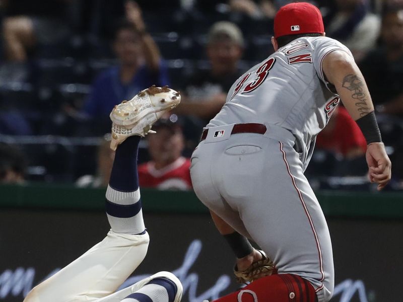 Aug 13, 2023; Pittsburgh, PA, USA; Pittsburgh Pirates catcher Endy Rodriguez (left) is out at first base on a pick-off as Cincinnati Reds first baseman Christian Encarnacion-Strand (33) makes a tag during the eighth inning at PNC Park. The Reds won 6-5 in ten innings. Mandatory Credit: Charles LeClaire-USA TODAY Sports