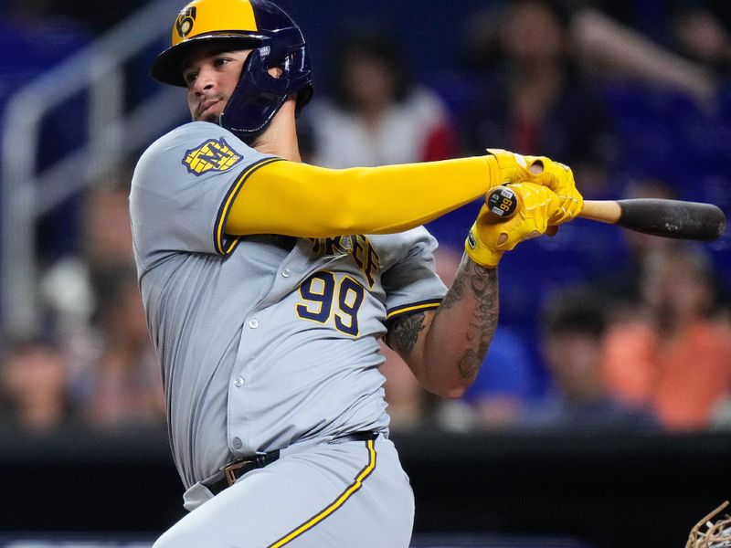 May 22, 2024; Miami, Florida, USA; Milwaukee Brewers first base Jake Bauers (9) hits a single during the eighth inning against the Miami Marlins at loanDepot Park. Mandatory Credit: Rich Storry-USA TODAY Sports