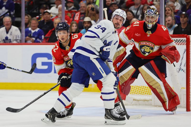 Apr 16, 2024; Sunrise, Florida, USA; Toronto Maple Leafs center Auston Matthews (34) calls for the puck as Florida Panthers defenseman Brandon Montour (62) defends during the third period at Amerant Bank Arena. Mandatory Credit: Sam Navarro-USA TODAY Sports