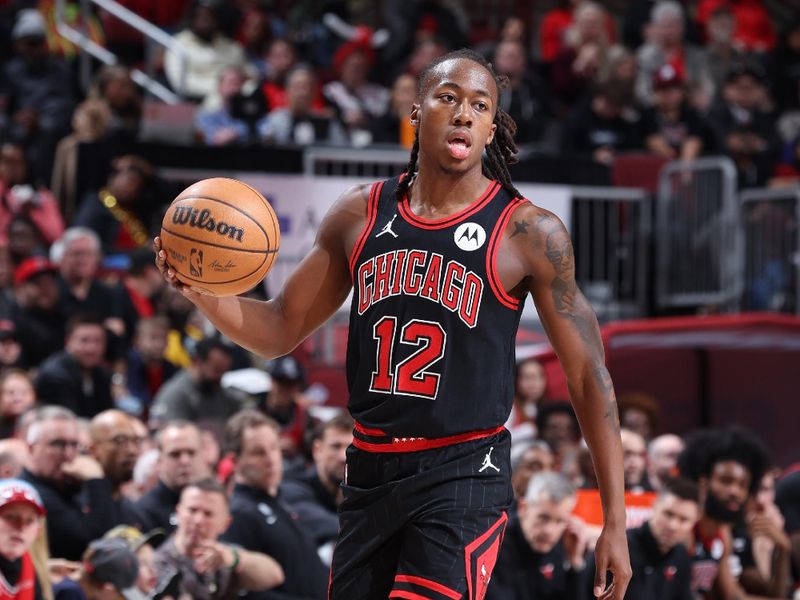 CHICAGO, IL - MARCH 25: Ayo Dosunmu #12 of the Chicago Bulls dribbles the ball during the game against the Washington Wizards on March 25, 2024 at United Center in Chicago, Illinois. NOTE TO USER: User expressly acknowledges and agrees that, by downloading and or using this photograph, User is consenting to the terms and conditions of the Getty Images License Agreement. Mandatory Copyright Notice: Copyright 2024 NBAE (Photo by Jeff Haynes/NBAE via Getty Images)