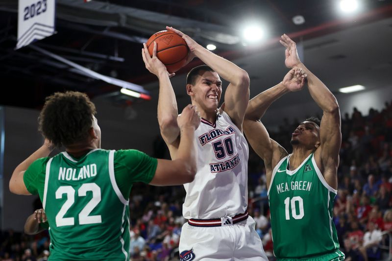 Jan 28, 2024; Boca Raton, Florida, USA; Florida Atlantic Owls center Vladislav Goldin (50) drives to the basket against North Texas Mean Green forward Robert Allen (10) during the second half at Eleanor R. Baldwin Arena. Mandatory Credit: Sam Navarro-USA TODAY Sports