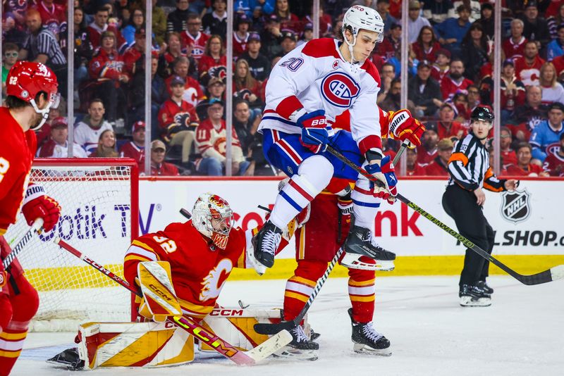 Mar 16, 2024; Calgary, Alberta, CAN; Montreal Canadiens left wing Juraj Slafkovsky (20) screens in front of Calgary Flames goaltender Dustin Wolf (32) as he makes a save during the third period at Scotiabank Saddledome. Mandatory Credit: Sergei Belski-USA TODAY Sports