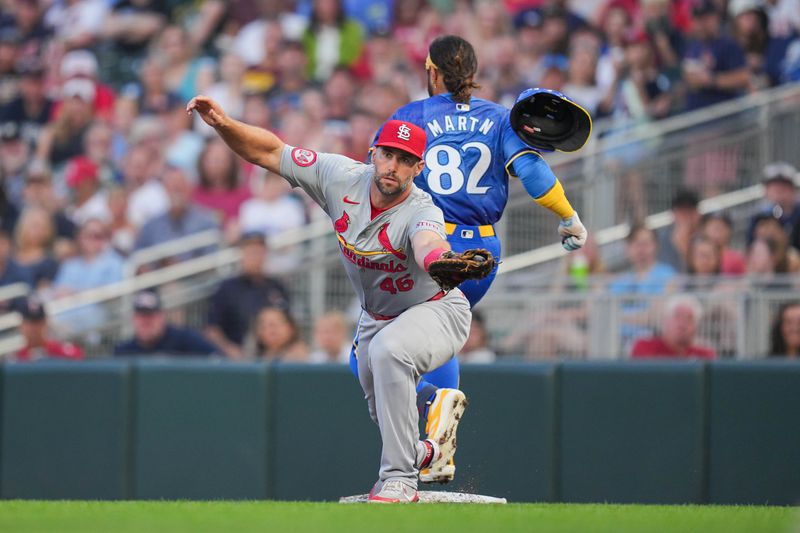 Aug 23, 2024; Minneapolis, Minnesota, USA; Minnesota Twins outfielder Austin Martin (82) beats out the throw to first against the St. Louis Cardinals first base Paul Goldschmidt (46) in the second inning at Target Field. Mandatory Credit: Brad Rempel-USA TODAY Sports