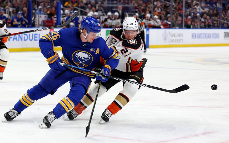 Feb 19, 2024; Buffalo, New York, USA;  Buffalo Sabres defenseman Rasmus Dahlin (26) clears the puck as Anaheim Ducks center Isac Lundestrom (21) defends during the first period at KeyBank Center. Mandatory Credit: Timothy T. Ludwig-USA TODAY Sports