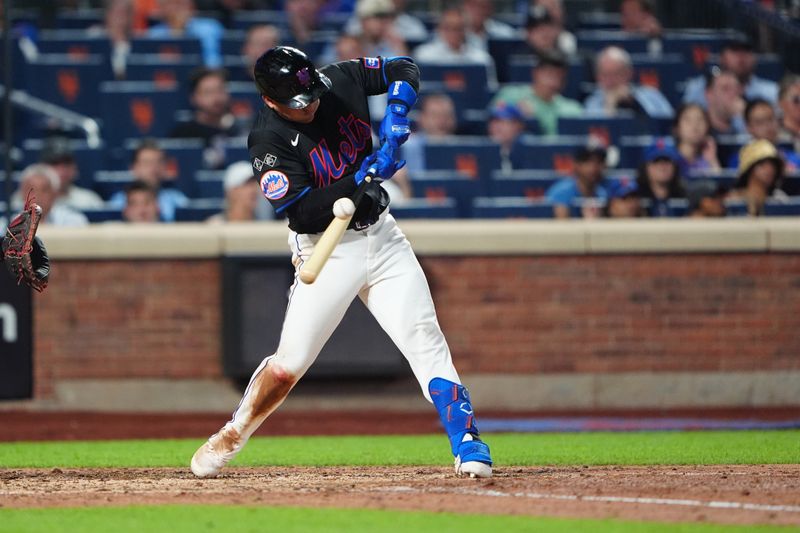 Jul 10, 2024; New York City, New York, USA; New York Mets second baseman Jose Iglesias (11) hits a double against the Washington Nationals during the eighth inning at Citi Field. Mandatory Credit: Gregory Fisher-USA TODAY Sports