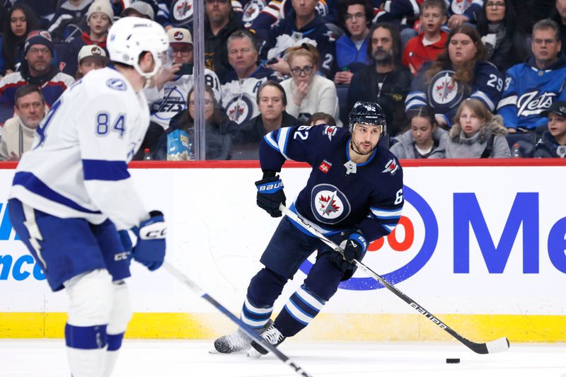 Jan 2, 2024; Winnipeg, Manitoba, CAN; Winnipeg Jets right wing Nino Niederreiter (62) skates past Tampa Bay Lightning left wing Tanner Jeannot (84) in the second period at Canada Life Centre. Mandatory Credit: James Carey Lauder-USA TODAY Sports