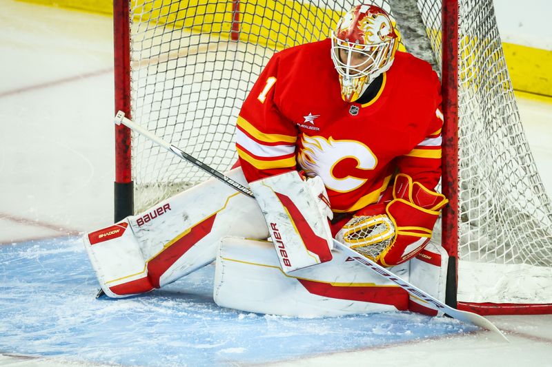 Dec 14, 2024; Calgary, Alberta, CAN; Calgary Flames goaltender Devin Cooley (1) guards his net during the warmup period against the Florida Panthers at Scotiabank Saddledome. Mandatory Credit: Sergei Belski-Imagn Images