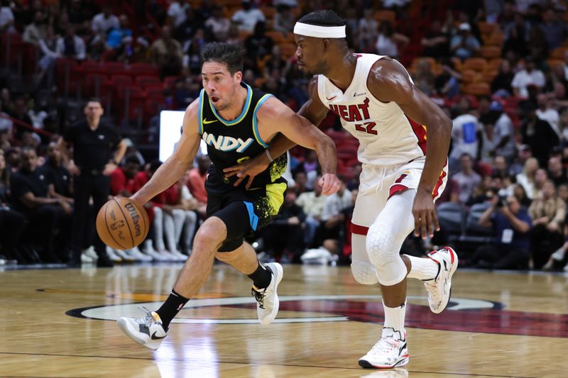 MIAMI, FLORIDA - DECEMBER 02: T.J. McConnell #9 of the Indiana Pacers drives against Jimmy Butler #22 of the Miami Heat during the fourth quarter of the game at Kaseya Center on December 02, 2023 in Miami, Florida. NOTE TO USER: User expressly acknowledges and agrees that, by downloading and or using this photograph, User is consenting to the terms and conditions of the Getty Images License Agreement. (Photo by Megan Briggs/Getty Images)
