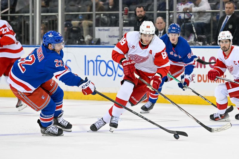 Oct 14, 2024; New York, New York, USA;  New York Rangers center Jonny Brodzinski (22) and Detroit Red Wings right wing Patrick Kane (88) chase a loose puck during the third period at Madison Square Garden. Mandatory Credit: Dennis Schneidler-Imagn Images