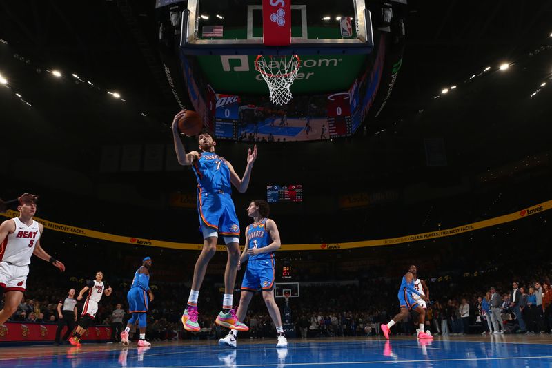 OKLAHOMA CITY, OK - MARCH 8:  Chet Holmgren #7 of the Oklahoma City Thunder grabs a rebound during the game against the Miami Heat on March 8, 2024 at Paycom Arena in Oklahoma City, Oklahoma. NOTE TO USER: User expressly acknowledges and agrees that, by downloading and or using this photograph, User is consenting to the terms and conditions of the Getty Images License Agreement. Mandatory Copyright Notice: Copyright 2024 NBAE (Photo by Zach Beeker/NBAE via Getty Images)