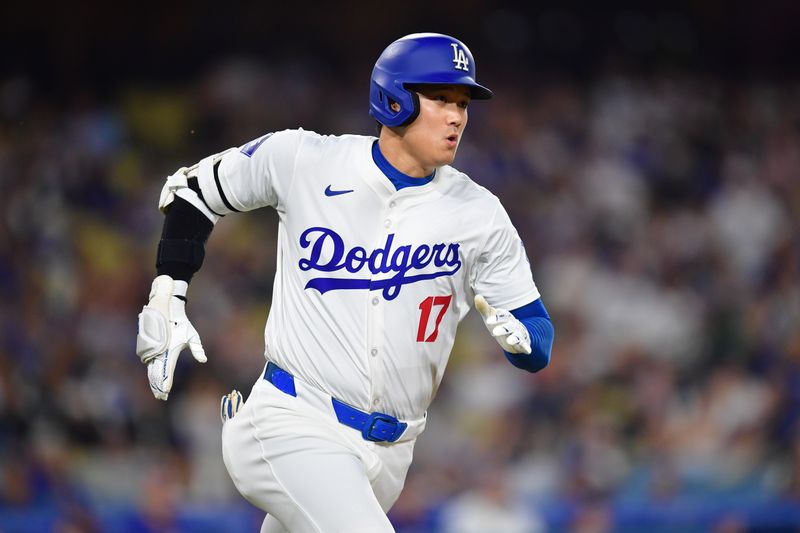 Sep 24, 2024; Los Angeles, California, USA; Los Angeles Dodgers designated hitter Shohei Ohtani (17) runs after hitting a ground rule double against the San Diego Padres during the first inning at Dodger Stadium. Mandatory Credit: Gary A. Vasquez-Imagn Images