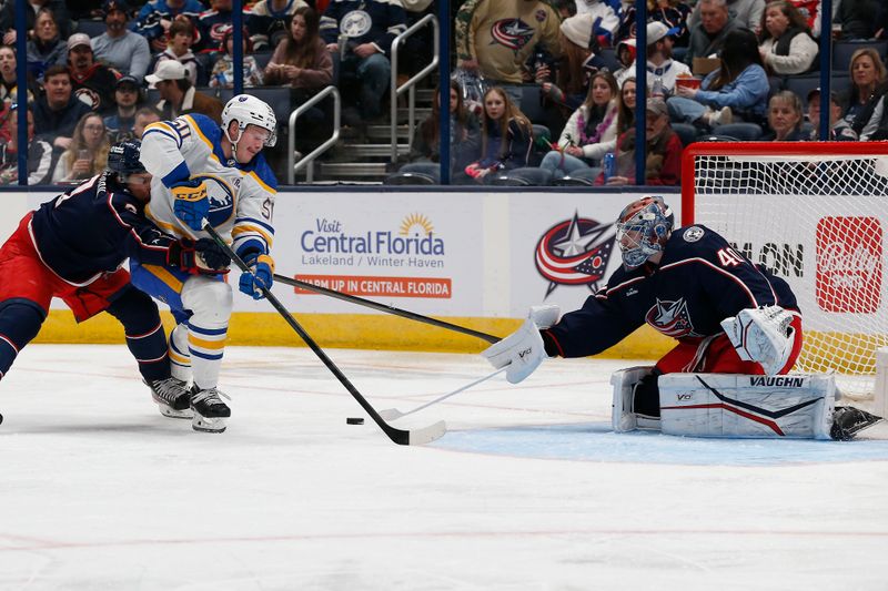 Feb 23, 2024; Columbus, Ohio, USA; Columbus Blue Jackets goalie Daniil Tarasov (40) poke checks the puck away from Buffalo Sabres left wing Eric Robinson (50) during the second period at Nationwide Arena. Mandatory Credit: Russell LaBounty-USA TODAY Sports