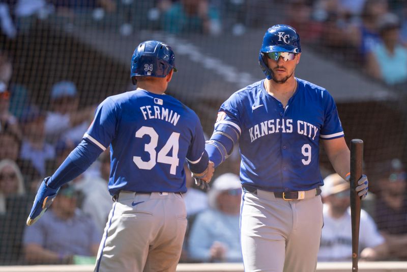 May 15, 2024; Seattle, Washington, USA; Kansas City Royals catcher Freddy Fermin (34)  is congratulated by first baseman Vinnie Pasquantino (9) after scoring a run during the eighth inning against the Seattle Mariners at T-Mobile Park. Mandatory Credit: Stephen Brashear-USA TODAY Sports