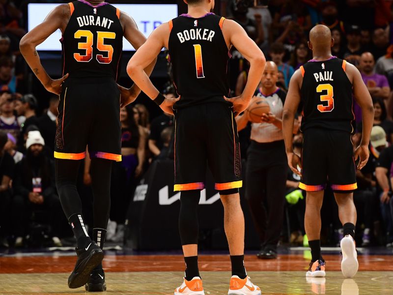 PHOENIX, AZ - APRIL  16: Kevin Durant #35, Devin Booker #1 and Chris Paul #3 of the Phoenix Suns stand on the court during Round One Game One of the 2023 NBA Playoffs on April 16, 2023 at Footprint Center in Phoenix, Arizona. NOTE TO USER: User expressly acknowledges and agrees that, by downloading and or using this photograph, user is consenting to the terms and conditions of the Getty Images License Agreement. Mandatory Copyright Notice: Copyright 2023 NBAE (Photo by Kate Frese/NBAE via Getty Images)