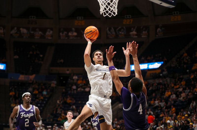 Mar 6, 2024; Morgantown, West Virginia, USA; West Virginia Mountaineers center Jesse Edwards (7) shoots in the lane over TCU Horned Frogs guard Jameer Nelson Jr. (4) during the second half at WVU Coliseum. Mandatory Credit: Ben Queen-USA TODAY Sports