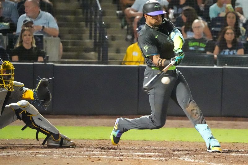 May 9, 2025; Tampa, Florida, USA; Tampa Bay Rays outfielder Christopher Morel (24) hits a single against the Milwaukee Brewers during the eighth inning at George M. Steinbrenner Field. Mandatory Credit: Dave Nelson-Imagn Images