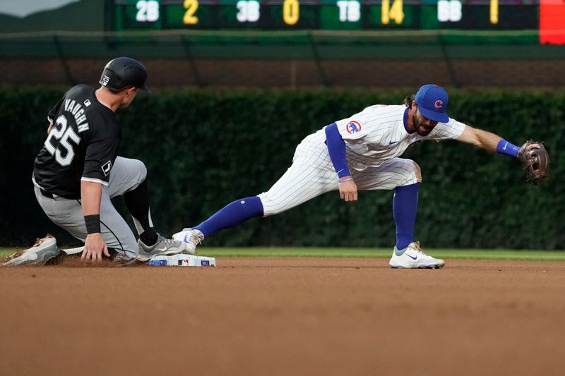 Jun 4, 2024; Chicago, Illinois, USA; Chicago Cubs shortstop Dansby Swanson (7) forces out Chicago White Sox first base Andrew Vaughn (25) at second base during the fourth inning at Wrigley Field. Mandatory Credit: David Banks-USA TODAY Sports
