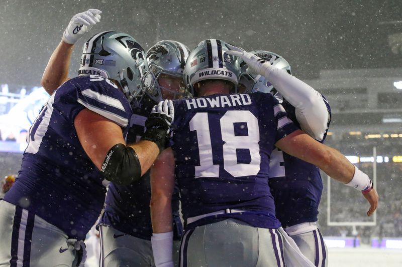 Nov 25, 2023; Manhattan, Kansas, USA; Kansas State Wildcats quarterback Will Howard (18) is congratulated by teammates after scoring a touchdown in the third quarter against the Iowa State Cyclones at Bill Snyder Family Football Stadium. Mandatory Credit: Scott Sewell-USA TODAY Sports