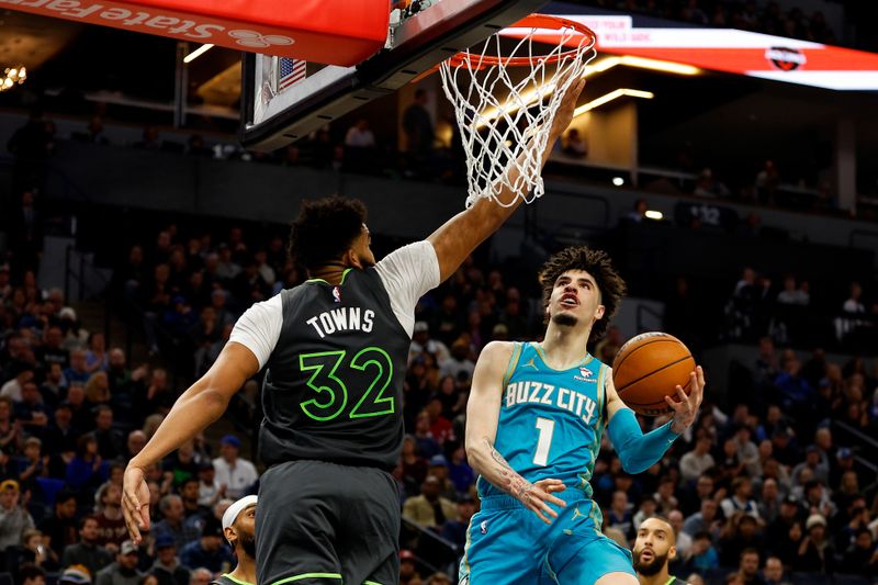 MINNEAPOLIS, MINNESOTA - JANUARY 22: LaMelo Ball #1 of the Charlotte Hornets goes up for a shot against Karl-Anthony Towns #32 of the Minnesota Timberwolves in the third quarter at Target Center on January 22, 2024 in Minneapolis, Minnesota. The Hornets won 128-125. NOTE TO USER: User expressly acknowledges and agrees that, by downloading and or using this photograph, User is consenting to the terms and conditions of the Getty Images License Agreement. (Photo by David Berding/Getty Images)