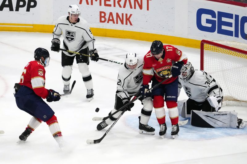 Jan 11, 2024; Sunrise, Florida, USA; Los Angeles Kings defenseman Jordan Spence (21) blocks the shot of Florida Panthers center Aleksander Barkov (16) during the second period at Amerant Bank Arena. Mandatory Credit: Jasen Vinlove-USA TODAY Sports