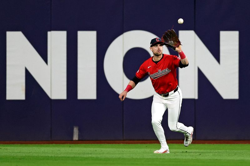 Oct 19, 2024; Cleveland, Ohio, USA; Cleveland Guardians outfielder Lane Thomas (8) catches a fly ball during the fifth inning against the New York Yankees during game five of the ALCS for the 2024 MLB playoffs at Progressive Field. Mandatory Credit: Scott Galvin-Imagn Images