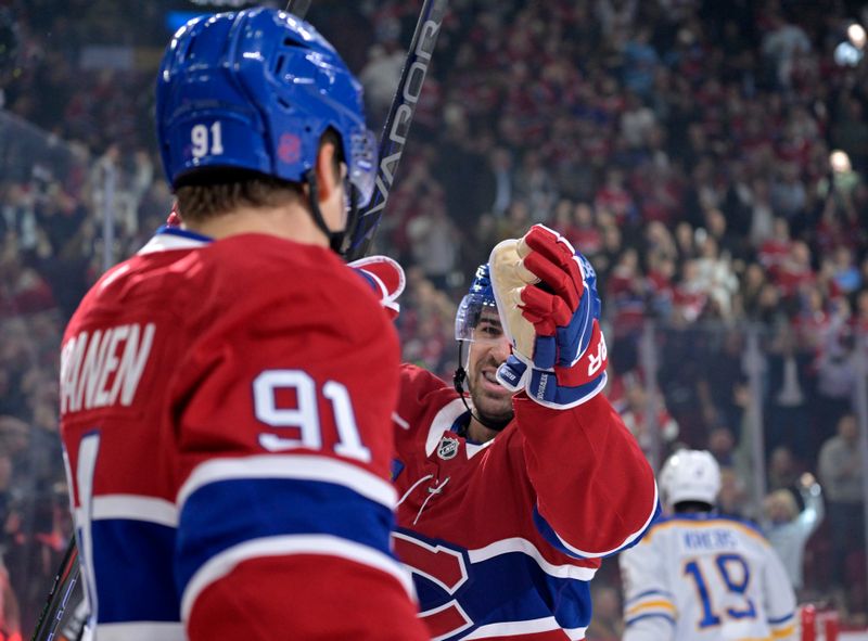 Oct 20, 2025; Montreal, Quebec, CAN; Montreal Canadiens forward Oliver Kapanen (91) celebrates with teammate forward Alex Newhook (15) after scoring a goal against the Buffalo Sabres during the first period at the Bell Centre. Mandatory Credit: Eric Bolte-Imagn Images