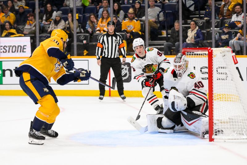 Jan 16, 2025; Nashville, Tennessee, USA;  Chicago Blackhawks goaltender Arvid Soderblom (40) blocks the shot of Nashville Predators center Colton Sissons (10) during the third period at Bridgestone Arena. Mandatory Credit: Steve Roberts-Imagn Images