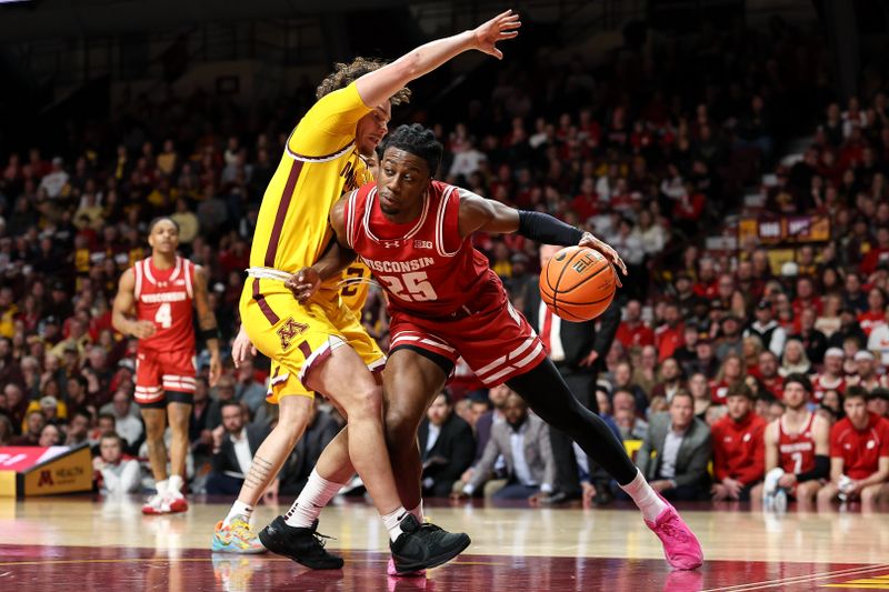 Mar 5, 2025; Minneapolis, Minnesota, USA; Wisconsin Badgers guard John Blackwell (25) works around Minnesota Golden Gophers guard Lu'Cye Patterson (25) during the second half at Williams Arena. Mandatory Credit: Matt Krohn-Imagn Images