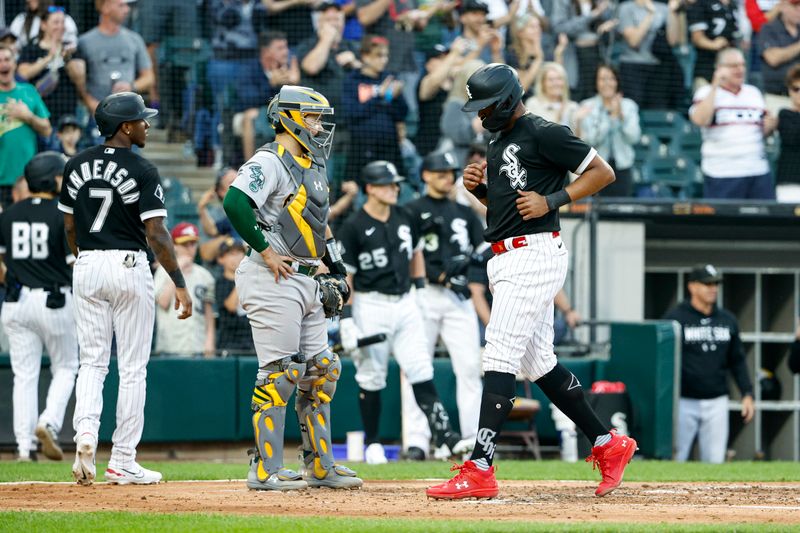 Aug 26, 2023; Chicago, Illinois, USA; Chicago White Sox designated hitter Eloy Jimenez (74) scores against the Oakland Athletics during the third inning at Guaranteed Rate Field. Mandatory Credit: Kamil Krzaczynski-USA TODAY Sports