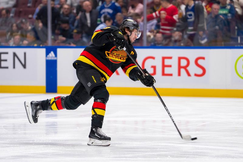 Mar 19, 2024; Vancouver, British Columbia, CAN; Vancouver Canucks defenseman Quinn Hughes (43) shoots against the Buffalo Sabres in the first period at Rogers Arena. Mandatory Credit: Bob Frid-USA TODAY Sports