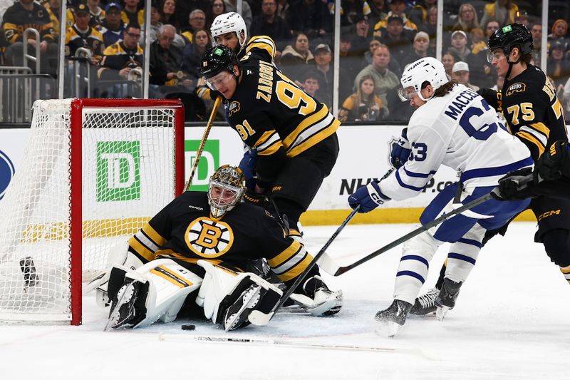 Mar 24, 2026; Boston, Massachusetts, USA;Toronto Maple Leafs left wing Matias MacCelli (63) tries to get to a loose puck in the crease of Boston Bruins goaltender Jeremy Swayman (1) during the first period at TD Garden. Mandatory Credit: Winslow Townson-Imagn Images