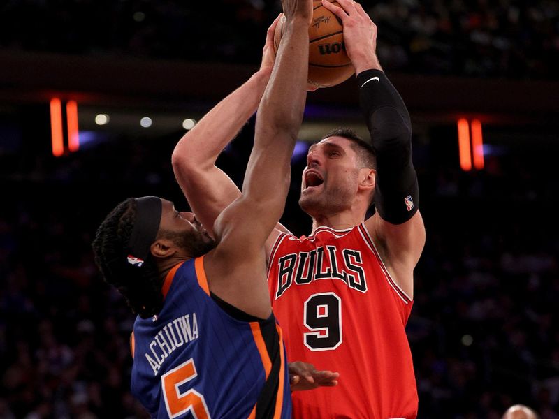 NEW YORK, NEW YORK - APRIL 14: Nikola Vucevic #9 of the Chicago Bulls heads for the net as Precious Achiuwa #5 of the New York Knicks defends during the second half at Madison Square Garden on April 14, 2024 in New York City. The New York Knicks defeated the Chicago Bulls 120-119 in OT. NOTE TO USER: User expressly acknowledges and agrees that, by downloading and or using this photograph, User is consenting to the terms and conditions of the Getty Images License Agreement. (Photo by Elsa/Getty Images)