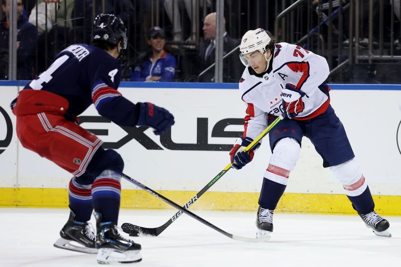 Jan 14, 2024; New York, New York, USA; Washington Capitals right wing T.J. Oshie (77) skates with the puck against New York Rangers defenseman Braden Schneider (4) during the third period at Madison Square Garden. Mandatory Credit: Brad Penner-USA TODAY Sports