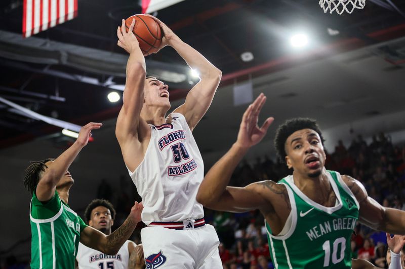 Jan 28, 2024; Boca Raton, Florida, USA; Florida Atlantic Owls center Vladislav Goldin (50) drives to the basket against the North Texas Mean Green during the second half at Eleanor R. Baldwin Arena. Mandatory Credit: Sam Navarro-USA TODAY Sports