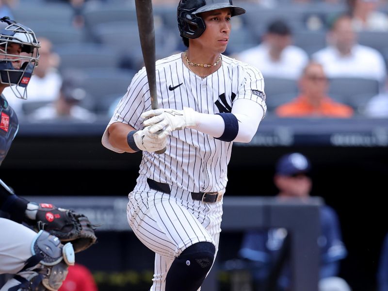 Jul 22, 2024; Bronx, New York, USA; New York Yankees second baseman Oswaldo Cabrera (95) follows through on a two run single against the Tampa Bay Rays during the fourth inning at Yankee Stadium. Mandatory Credit: Brad Penner-USA TODAY Sports