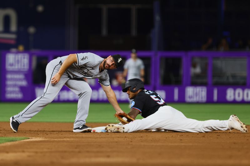 Jul 5, 2024; Miami, Florida, USA; Miami Marlins right fielder Dane Myers (54) steals second base against Chicago White Sox shortstop Paul DeJong (29) during the second inning at loanDepot Park. Mandatory Credit: Sam Navarro-USA TODAY Sports