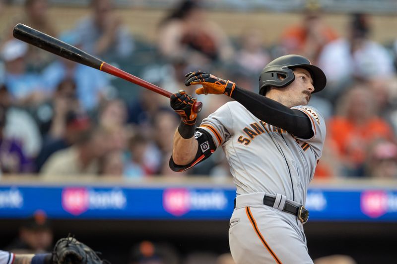 May 23, 2023; Minneapolis, Minnesota, USA; San Francisco Giants center fielder Mike Yastrzemski (5) hits a single in the fourth inning against the Minnesota Twins at Target Field. Mandatory Credit: Jesse Johnson-USA TODAY Sports