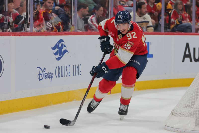 Nov 30, 2024; Sunrise, Florida, USA; Florida Panthers left wing Tomas Nosek (92) moves the puck behind the net against the Carolina Hurricanes during the first period at Amerant Bank Arena. Mandatory Credit: Sam Navarro-Imagn Images