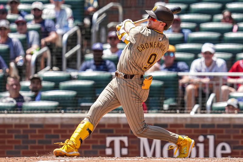 May 20, 2024; Cumberland, Georgia, USA; San Diego Padres first baseman Jake Cronenworth (9) singles to drive in two runs against the Atlanta Braves during the eighth inning at Truist Park. Mandatory Credit: Dale Zanine-USA TODAY Sports