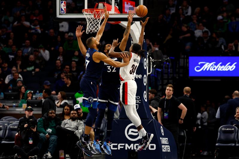 MINNEAPOLIS, MINNESOTA - MARCH 04: Jabari Walker #34 of the Portland Trail Blazers goes up for a shot against Rudy Gobert #27 and Karl-Anthony Towns #32 of the Minnesota Timberwolves in the third quarter at Target Center on March 04, 2024 in Minneapolis, Minnesota. The Timberwolves defeated the Trail Blazers 119-114. NOTE TO USER: User expressly acknowledges and agrees that, by downloading and or using this photograph, User is consenting to the terms and conditions of the Getty Images License Agreement. (Photo by David Berding/Getty Images)