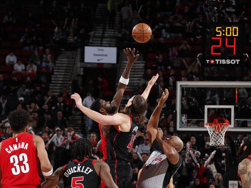 PORTLAND, OR - MARCH 9: Deandre Ayton #2 of the Portland Trail Blazers and Kelly Olynyk #41 of the Toronto Raptor go up for a jump ball on March 9, 2024 at the Moda Center Arena in Portland, Oregon. NOTE TO USER: User expressly acknowledges and agrees that, by downloading and or using this photograph, user is consenting to the terms and conditions of the Getty Images License Agreement. Mandatory Copyright Notice: Copyright 2024 NBAE (Photo by Cameron Browne/NBAE via Getty Images)