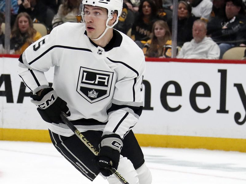 Feb 18, 2024; Pittsburgh, Pennsylvania, USA;  Los Angeles Kings defenseman Andreas Englund (5) handles the puck against the Pittsburgh Penguins during the third period at PPG Paints Arena. Los Angeles won 2-1. Mandatory Credit: Charles LeClaire-USA TODAY Sports