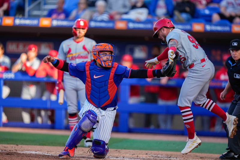 Mar 19, 2024; Port St. Lucie, Florida, USA; New York Mets catcher Francisco Alvarez (4) tags out St. Louis Cardinals third baseman Cesar Prietoduring the second inning at Clover Park. Mandatory Credit: Rich Storry-USA TODAY Sports