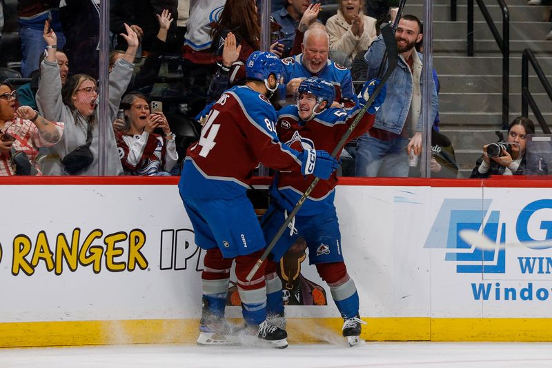 Dec 11, 2025; Denver, Colorado, USA; Colorado Avalanche center Gavin Brindley (54) celebrates his goal with defenseman Brent Burns (84) in the second period against the Florida Panthers at Ball Arena. Mandatory Credit: Isaiah J. Downing-Imagn Images