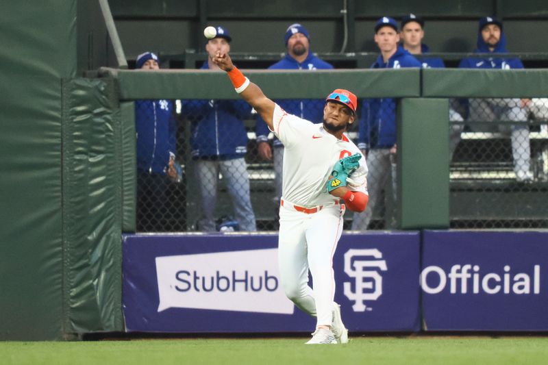 May 14, 2024; San Francisco, California, USA; San Francisco Giants center fielder Luis Matos (29) throws the ball towards third base against the Los Angeles Dodgers during the fourth inning at Oracle Park. Mandatory Credit: Kelley L Cox-USA TODAY Sports