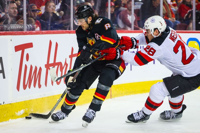 Dec 9, 2023; Calgary, Alberta, CAN; Calgary Flames defenseman Chris Tanev (8) and New Jersey Devils right wing Timo Meier (28) battle for the puck during the first period at Scotiabank Saddledome. Mandatory Credit: Sergei Belski-USA TODAY Sports