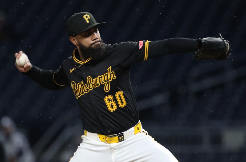 May 20, 2025; Pittsburgh, Pennsylvania, USA; Pittsburgh Pirates relief pitcher Dennis Santana (60) pitches against the Cincinnati Reds during the eighth inning at PNC Park. Mandatory Credit: Charles LeClaire-Imagn Images